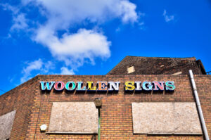 Woollens Signs