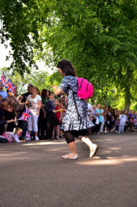 Sheffield Olympic Torch Relay 2012 A Woman scurries across the path of the Torch Relay, Camera in hand. View on Flickr…